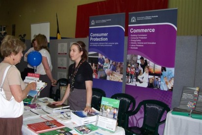 A photograph of the Consumer protection booth at the Seniors’ expo Bunbury with the staff handing out WA ScamNet balloons.