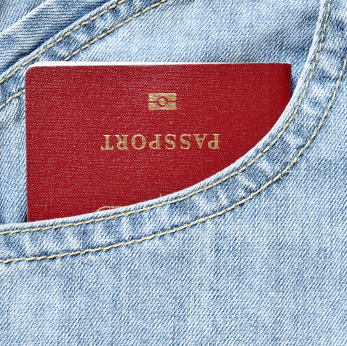 A red passport in a denim pocket 