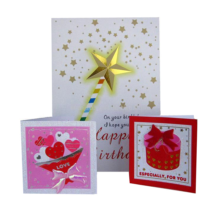 Three greeting cards one with an image of a wand on it , one with a picture of a pink present and the last one with a bunch of love hearts.