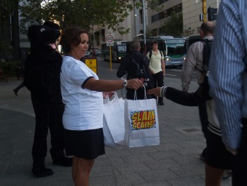 community education officer and Jet handing out "SlamScams" bags
