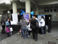 A shot of the booth at the ScamNet launch showing consumers picking up balloons and bags